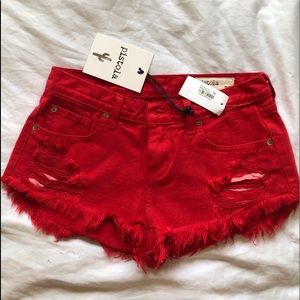 PISTOLA red shorts with rips